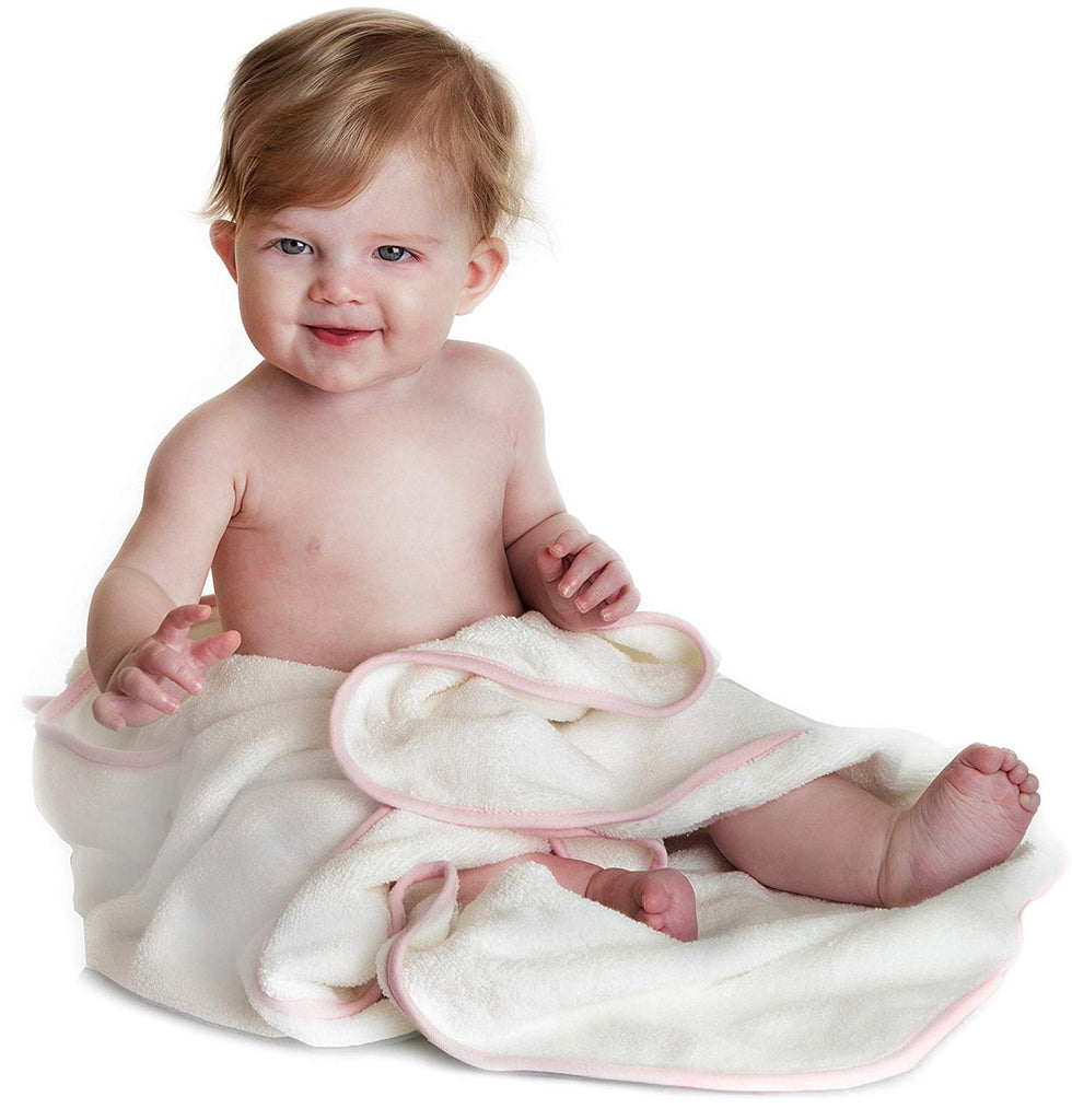 Alt = Baby sitting with Pink Unicorn hooded towel wrapped around